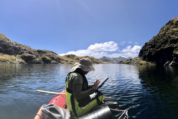 Mckayla sitting in a small boat, surveying.